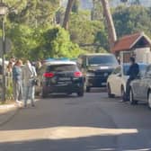 A police car patrols the street outside the Marbella Airbnb on April 25. 