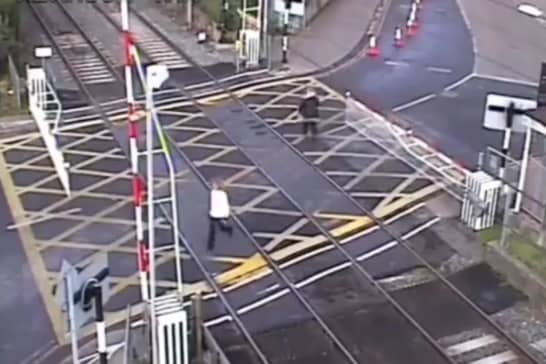 Woman crushed by level crossing barrier.