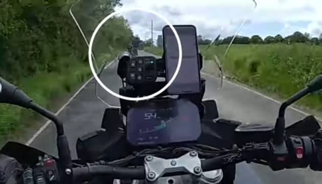 Speeding biker pulls a wheelie.