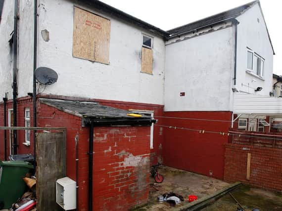 A rescuer, thought to be a neighbour, tried to climb in using a veranda at the back. Picture: Peter Byrne/PA Wire.