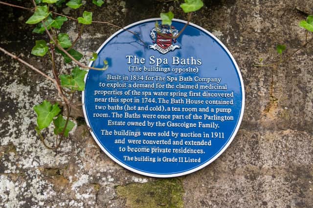 A plaque telling the story of the Spa Baths
