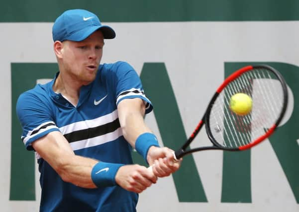 Britain's Kyle Edmund returns the ball to Hungary's Marton Fucsovics.