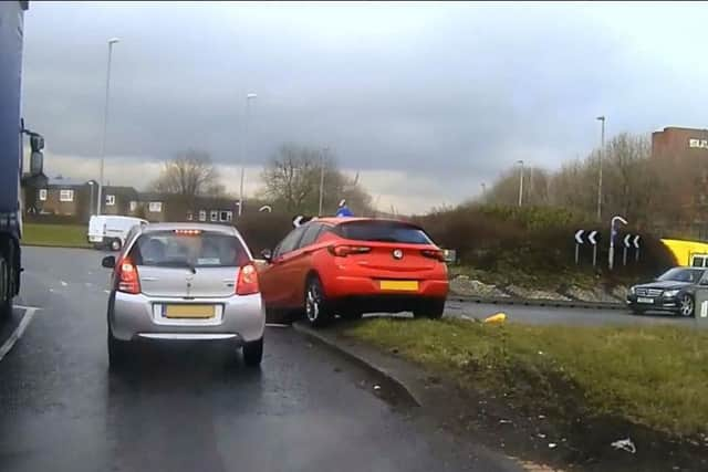 The police chase in progress as the car (the red Vauxhall) makes its escape