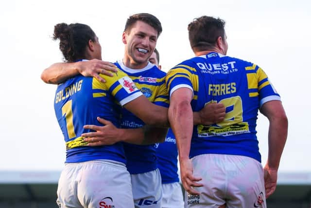 Ashton Golding of Leeds, left, celebrates his try with Tom Briscoe and Brett Ferres. Picture: Alex Whitehead/SWpix.com