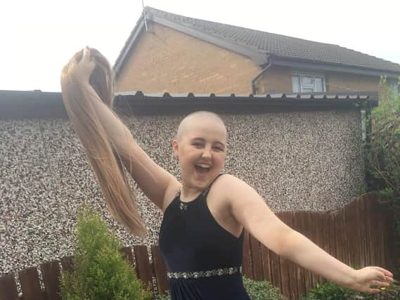 Annie bravely shows off her wig at her school ball.