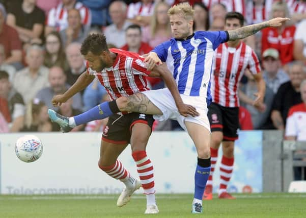 Sheffield Wednesdays Ash Baker, right, does his best to halt Lincoln Citys Matt Green at Sincil Bank (Picture: Steve Ellis).