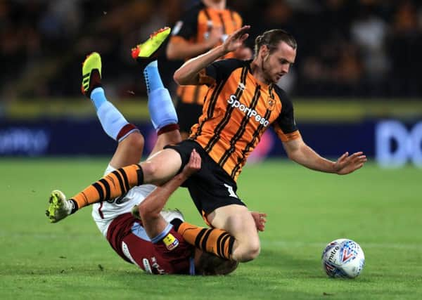 Hull Citys Will Keane tangles with Aston Villas Birkir Bjarnason at the KCOM Stadium last night.  The home side took an early lead against Villa, last seasons Championship play-off finalists, who hit back to win 3-1 (PIcture: Mike Egerton/PA Wire).