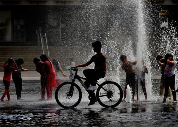 Children play in the water fountains at City Park, Bradford, as the temperatures rise..18th July 2016 ..Picture by Simon Hulme