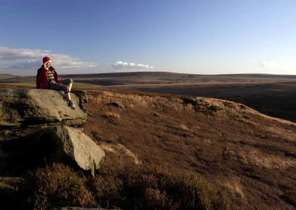 A walker enjoys the view overlooking the wild fells of the South Penines (Steve Morgan).