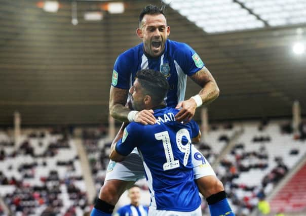 Going through: Steven Fletcher congratulates Marco Matias after his opener for Sheffield Wednesday at Sunderland.