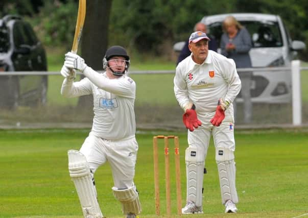 Hitting out: 
Burleybatsman Lewis Bolton on his way to 49 
in a seventh-wicket stand of 104 with Jason Wright (73).