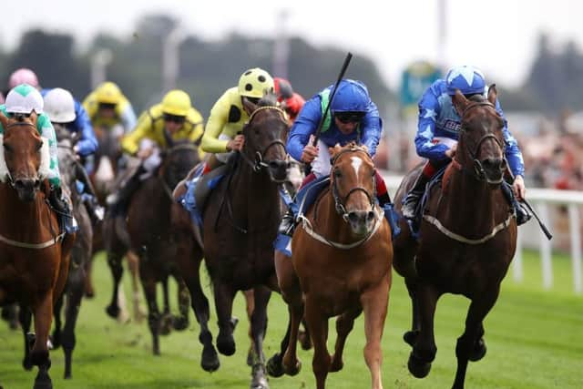 Poet's Society & Frankie Dettori (centre right) win the Clipper Logistics Handicap at York to give Middleham trainer Mark Johnston the title of winning-most trainer in British history. Picture: Tim Goode/PA Wire