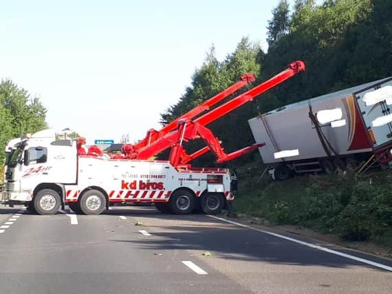 The lorry is lifted from the embankment. PIC: Highways England