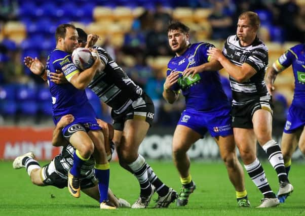 Warrington's Tyrone Roberts is tackled by Hull FC's Mickey Paea and Danny Washbrook. Picture: Alex Whitehead/SWpix.com