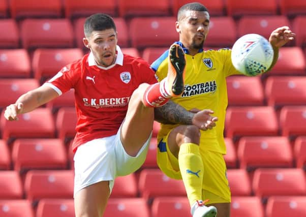 New deal offered: To Barnsley's Alex Mowatt, left.