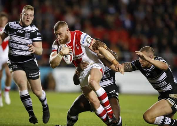 St Helens' Luke Thompson drives to the line to score a try past Hull FC's Masimbaashe Matongo (left) and Dean Hadley (right).