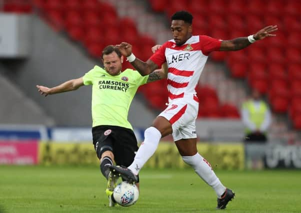 Richard Stearman of Sheffield Utd tackles Mallik Wilks of Doncaster Rovers.