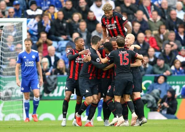 Short-lived joy: Huddersfield Town's Mathias Zanka Jorgensen is mobbed after scoring their early opener.