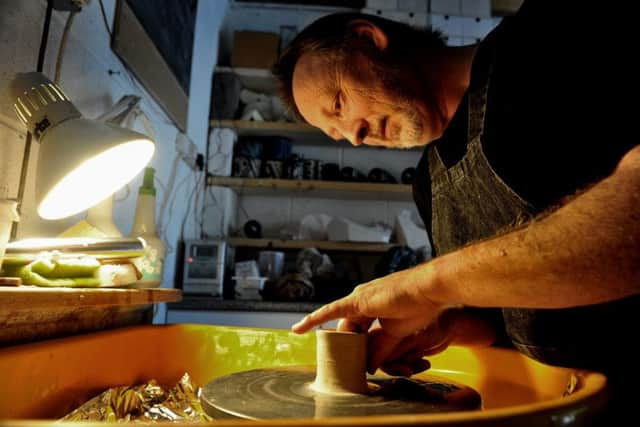 Potter Eric Moss from Asenby near Thirsk working in his studio in readiness for the forthcoming York Ceramics Fair .