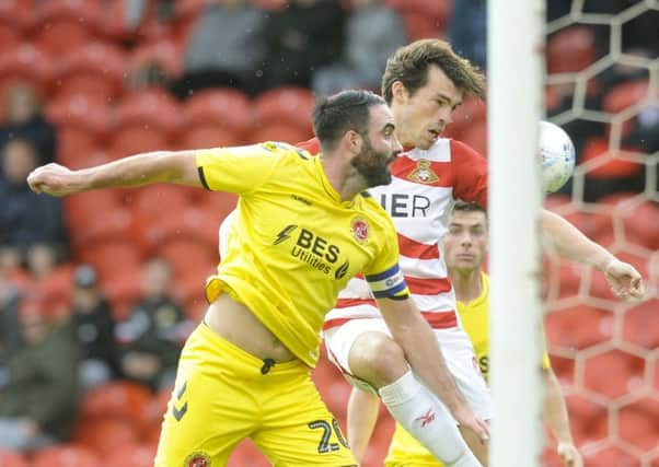 Missed chance: Rovers' John Marquis heads wide under pressure from Craig Morgan. Picture: Dean Atkins