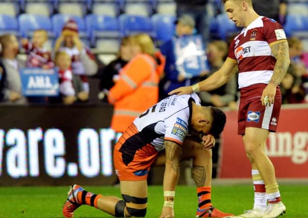 Jesse Sene-Lefao is consoled by Sam Powell.  Picture Bruce Rollinson