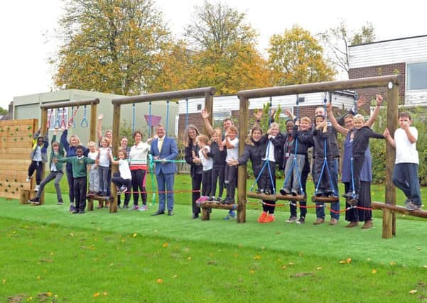 5 October  2018......    Stuart Andrew MP with PTA members and children with the new trim trail play equipment at Broadgate Primary School in Horsforth.  Picture Tony Johnson.