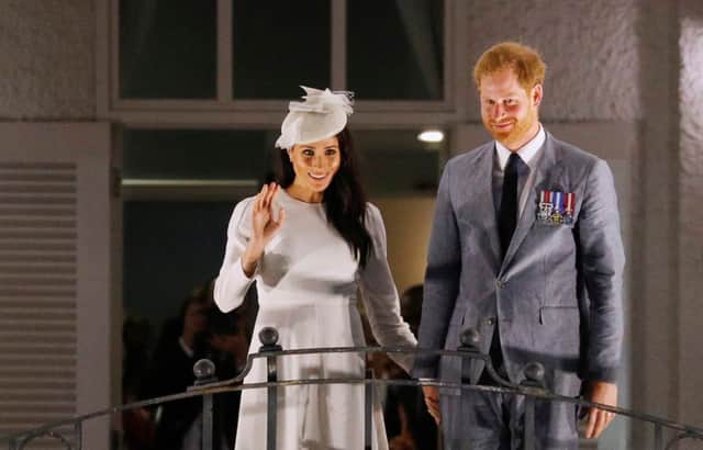 The Duke and Duchess of Sussex wave from the balcony of the Grand Pacific Hotel, in Suva, Fiji, on day one of the royal couple's visit to Fiji.