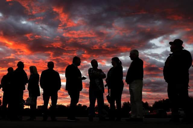 Voters line up to cast their ballots shortly before the polls open in the midterm elections at First Church in Owasso, Okla (Mike Simons/Tulsa World via AP)