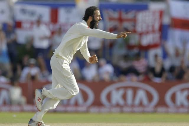 England's Moeen Ali celebrates taking the wicket of Sri Lanka's Niroshan Dickwella during the second day of the first test. (AP Photo/Eranga Jayawardena)