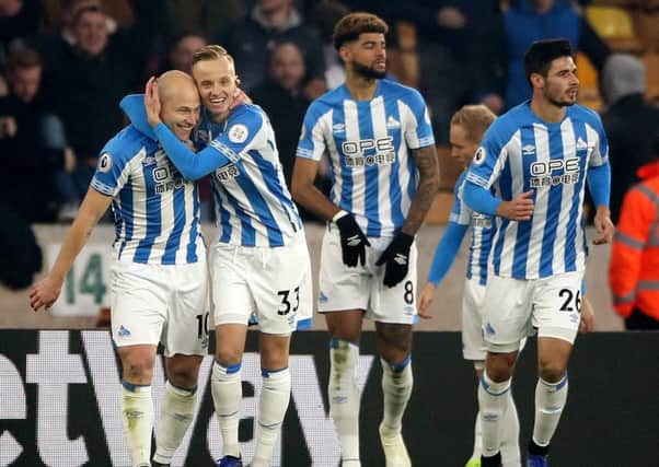 DOUBLE-DELIGHT: Huddersfield Town's Aaron Mooy (left) celebrates scoring his side's first goal of the game at Molineux. Picture: Nick Potts/PA