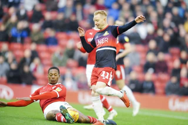 TIGHT TUSSLE: Barnsley's Ethan Pinnock disposesses Doncaster Rovers' Ali Crawford. Picture: Dean Atkins.