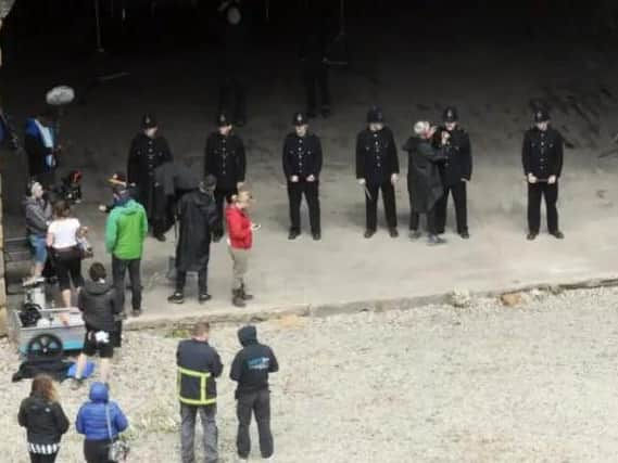 Actors in 1930s police uniforms beneath Holbeck Viaduct