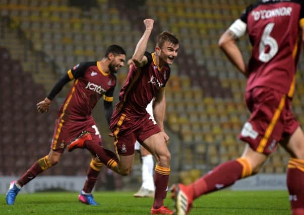 Battling: George Miller celebrates scoring Bradford's fourth goal against Peterbrough. Picture: Bruce Rollinson