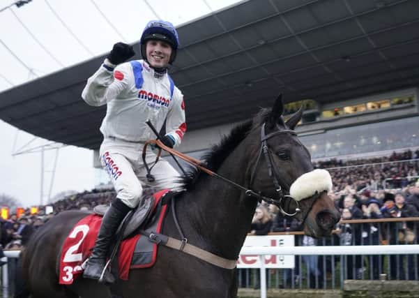 Harry Cobden celebrates the King Goerge Chase success of Clan Des Obeaux.