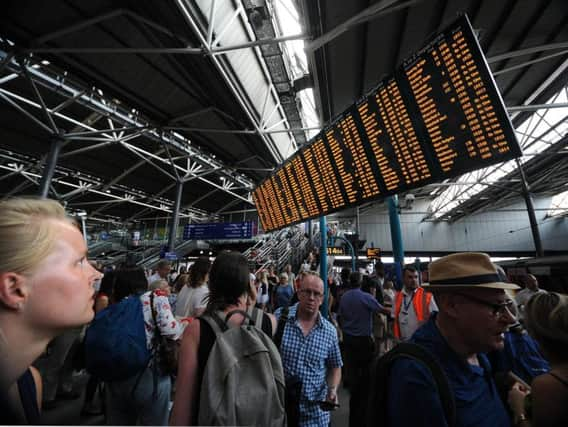 Commuters wait for news during last year's rail troubles.