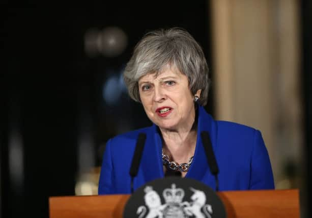 Theresa May outside 10 Downing Street after MPs rejected Labour's motion of no confidence