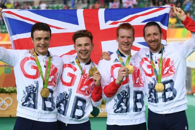 Britain's Edward Clancy and Britain's Bradley Wiggins, right, after winning gold in the team pursuit at Rio 2016 (Picture: ERIC FEFERBERG/AFP/Getty Images)