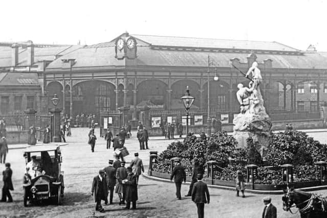 Horse carriages and motor cars outside Paragon station.