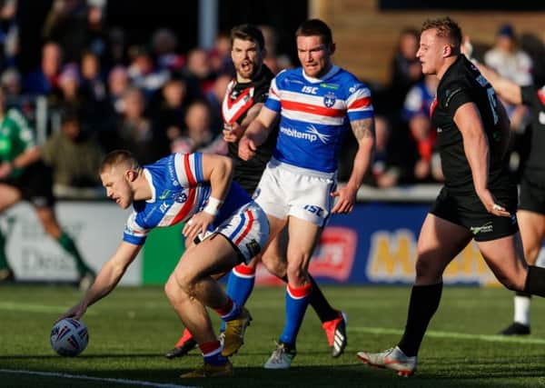 Wakefield Trinity's Ryan Hampshire scores a try.