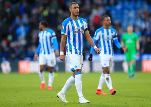 Huddersfield Town's Mathias Zanka Jorgensen (centre) leaves the pitch.