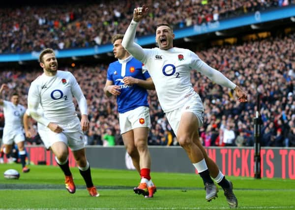 England's Jonny May celebrates scoring aganst France.