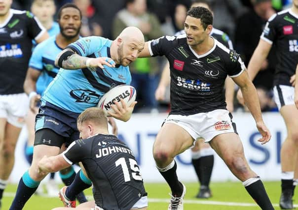 Widnes' Jordan Johnson  tackles Featherstone's John Davies.