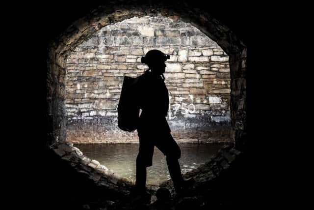 A man urban caving as an underground network of rivers are opened up to the public for an audio-visual spectacular during the Sheffield Adventure Film Festival. Picture: Danny Lawson/PA