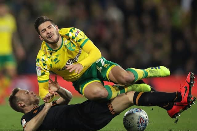 Hull City's Todd Kane fouls Norwich City's Emi Buendia (top) resulting in a yellow card (Pictures: PA)