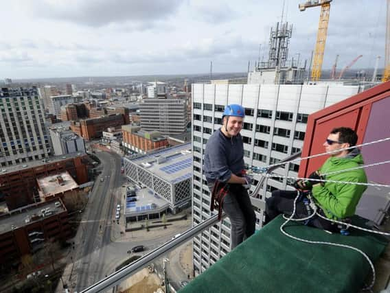 Ben White gets ready to abseil down the CVL building in Leeds earlier today.