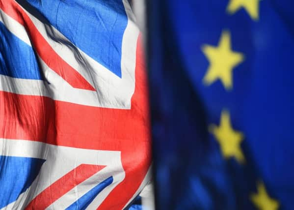 File photo dated 28/01/19 of Union and European Union flags outside the Houses of Parliament, London. Theresa May has warned MPs that if they fail to back her Brexit deal at the third time of asking then Brussels might insist on a lengthy delay, potentially scuppering chances of leaving the European Union altogether.