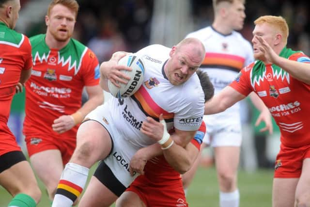 Bulls' Steve Crossley is brought to ground.