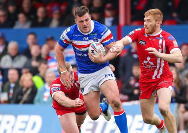 Wakefield's Joe Arundel makes a break from Salford's Joey Lussick and Kris Welham. Picture: Alex Whitehead/SWpix.com