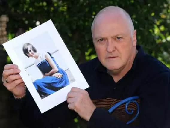 Colin Frost holds a photo of his sister, Elsie.