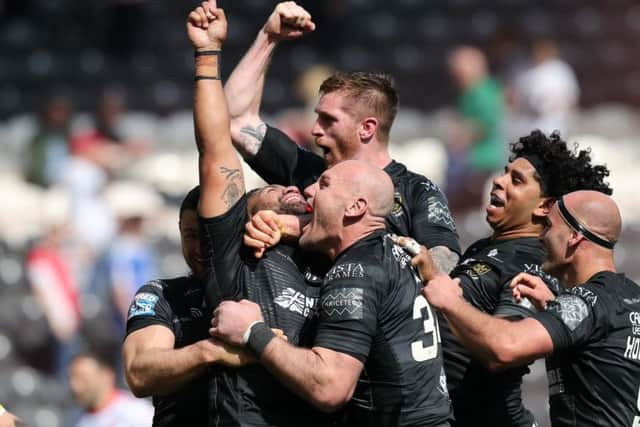 Mickey Paea of Hull FC celebrates a try with teammates.